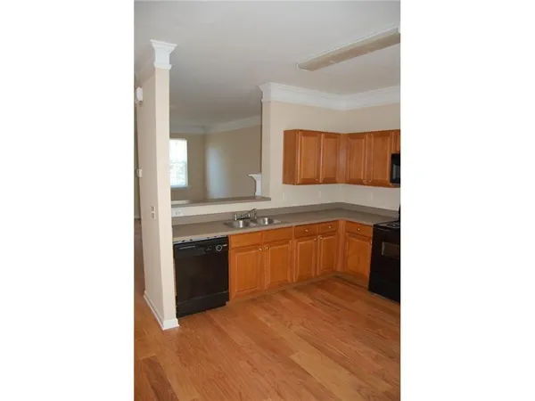 a kitchen with granite countertop a sink and a stove top oven