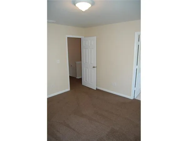 a view of a room with a white wall
