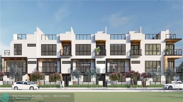 a front view of a residential apartment building with a yard