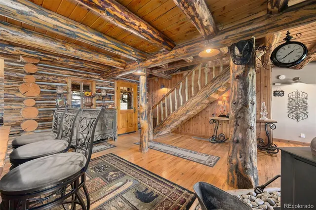 a dining room with furniture and wooden floor
