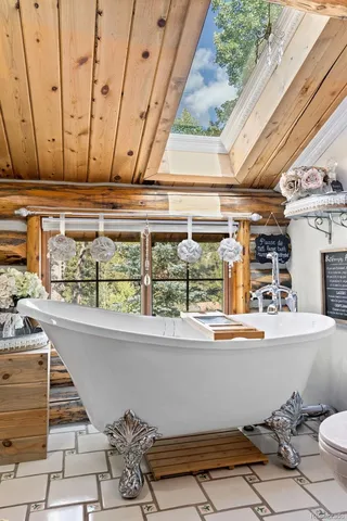 a bedroom with bed and wooden floor