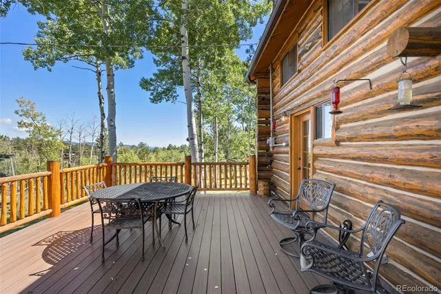 a view of a wooden chairs and table in patio