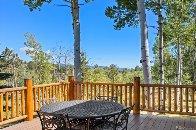 a view of house with backyard and outdoor seating