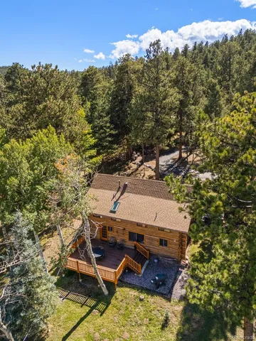 a view of a house with a yard balcony and tree