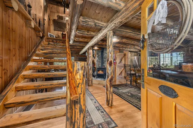 a living room with fireplace furniture and a wooden floor