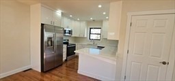 31 Niagara Street Fall River, MA 02721 - Photo 4 of 19 a kitchen with a refrigerator and a sink