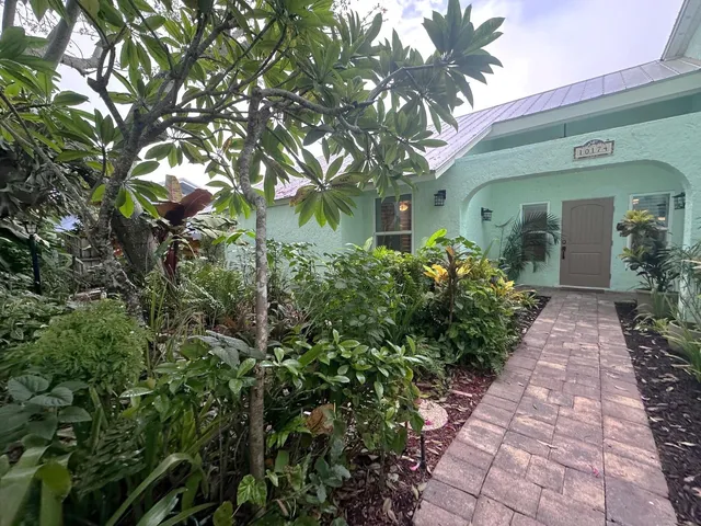 a front view of a house with lots of green space