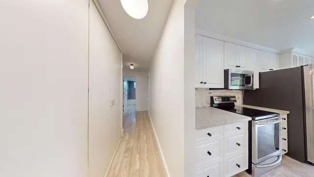 a view of a room with wooden floor