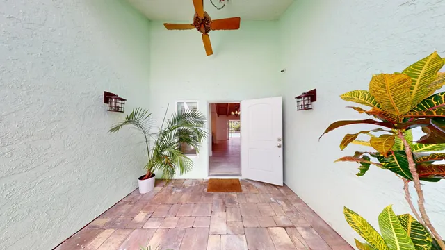 a view of entryway with paintings on the wall