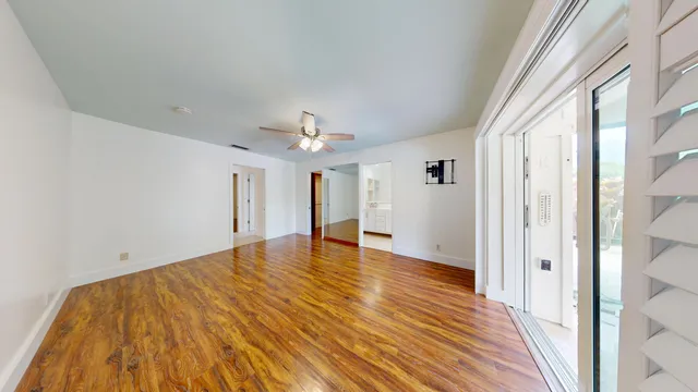 a spacious bathroom with a double vanity sink toilet mirror and next to a window