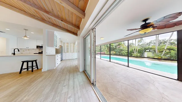 a view of hallway with furniture and a large window