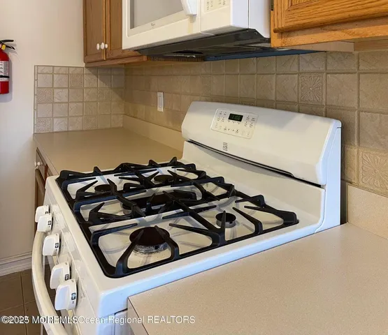 a close up of a stove top oven sitting inside of a kitchen
