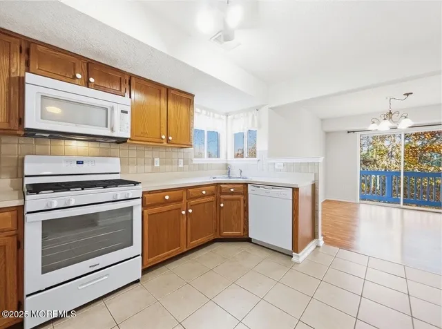 a kitchen with a stove top oven sink and cabinets
