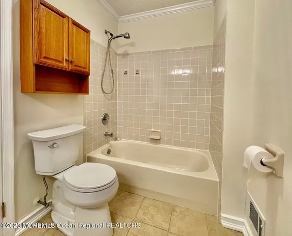 a bathroom with a toilet and shower