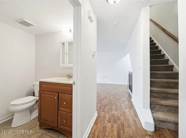 a bathroom with a sink a toilet and a mirror