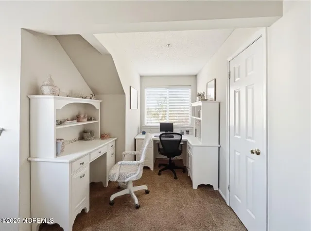 a workspace with a desk and chair with wooden floor