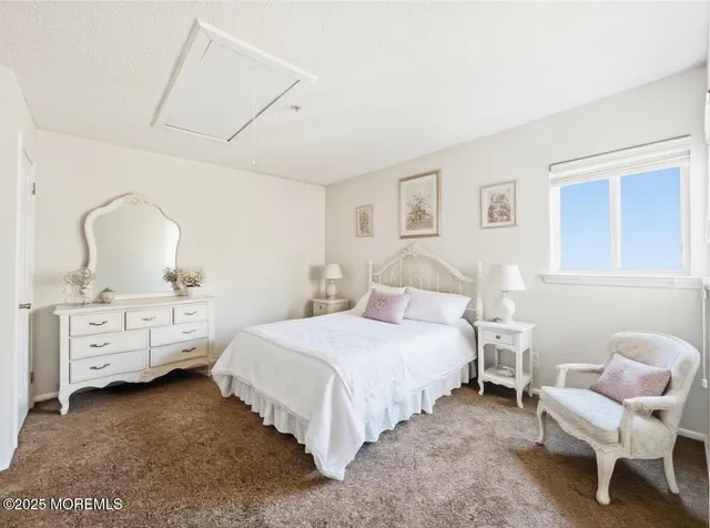 a bedroom with a bed and a chair