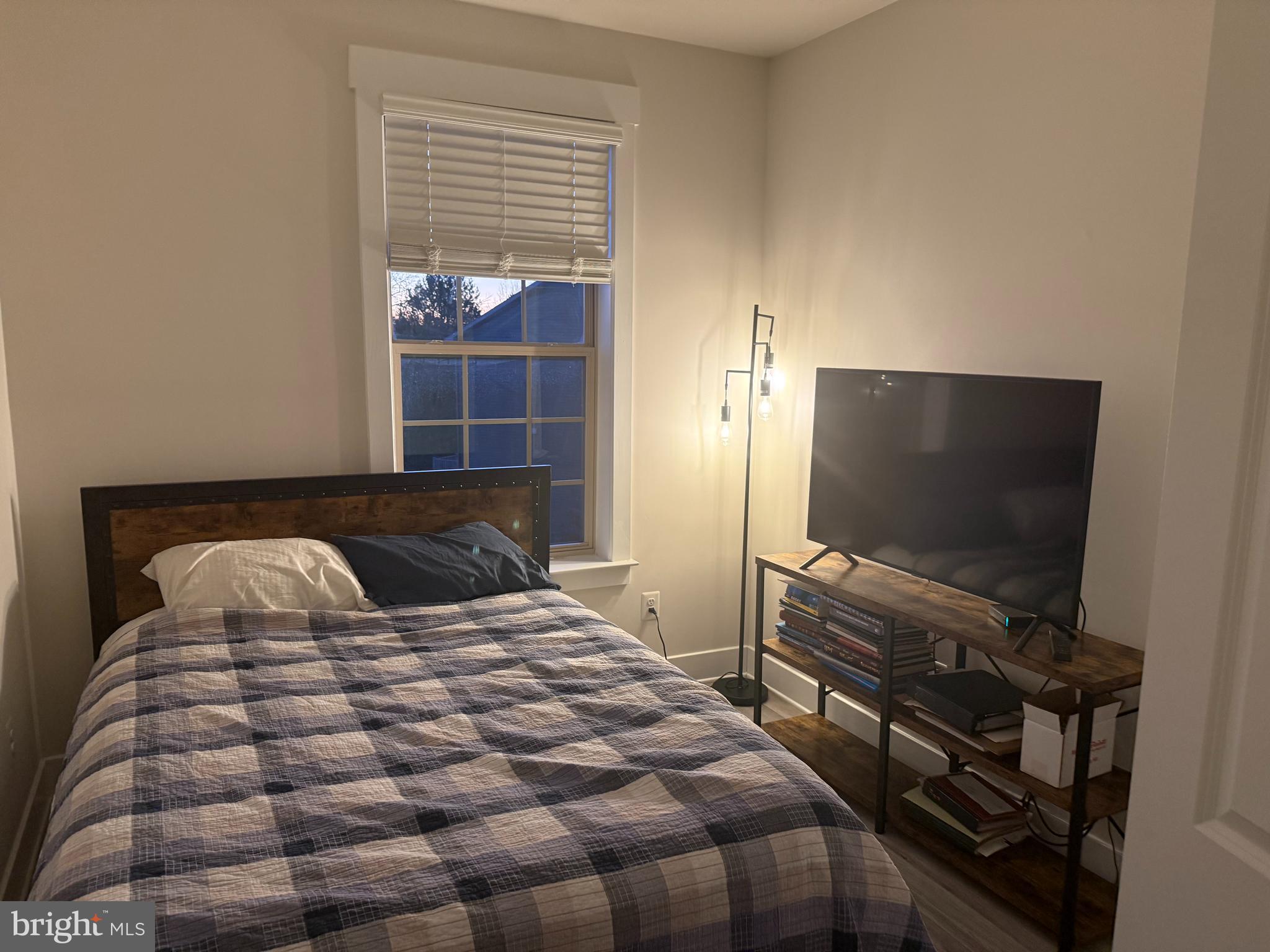 2932 Osprey Way North Frederick, MD 21701 - Photo 16 of 42 a bedroom with a bed and a flat screen tv