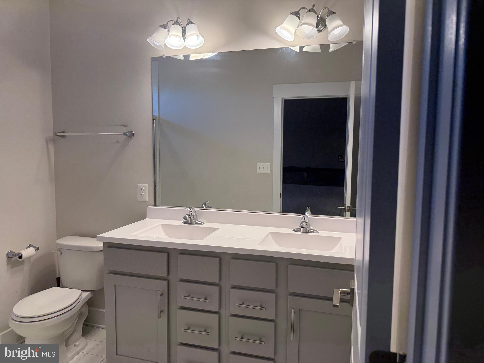 2932 Osprey Way North Frederick, MD 21701 - Photo 36 of 42 a bathroom with a toilet sink and mirror