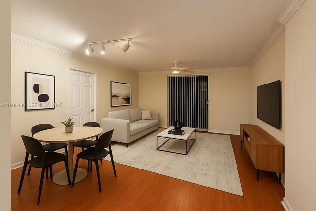 a living room with furniture a flat screen tv and a wooden floor