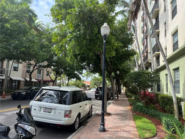 a view of a white house and a yard fire pit