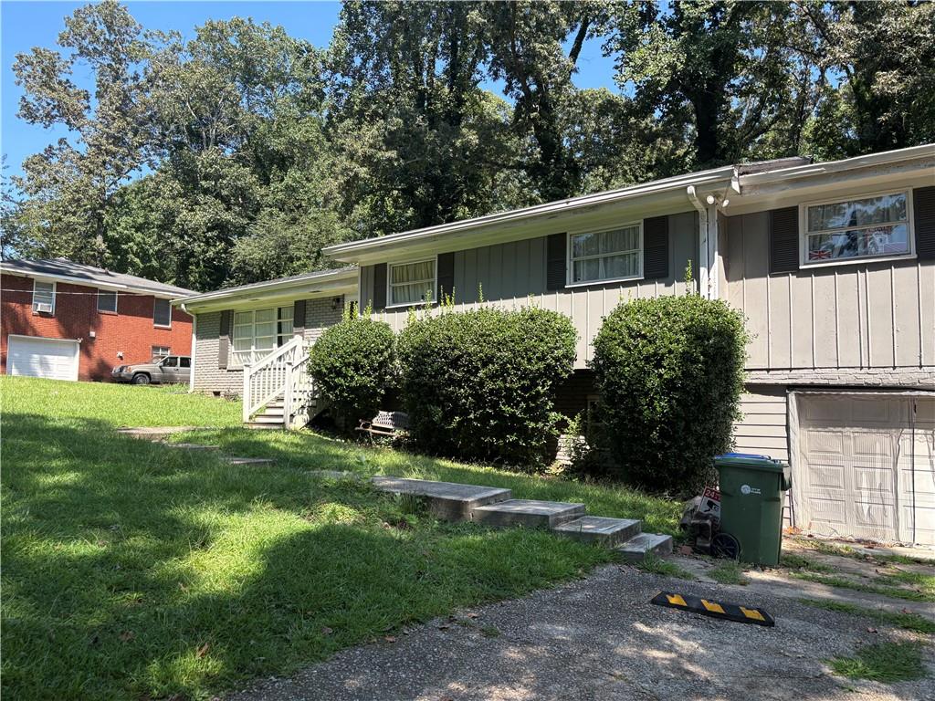 a front view of house with yard and green space