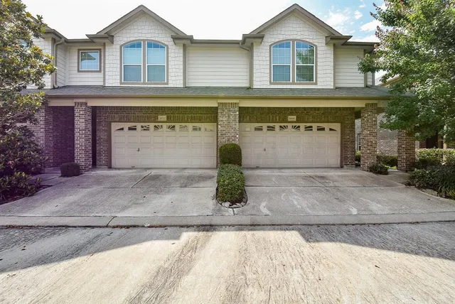 a front view of a house with garage