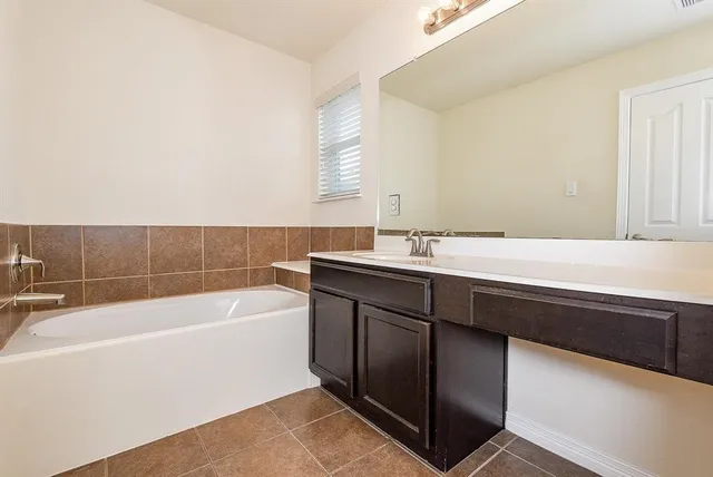 a bathroom with a bathtub and a sink