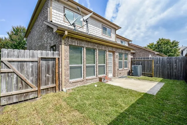a backyard of a house with table and chairs