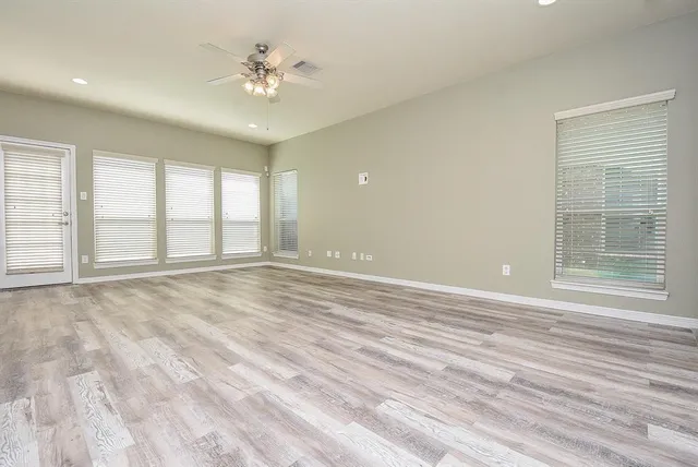 wooden floor in an empty room with a window