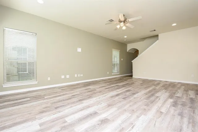 a view of a livingroom with a ceiling fan and window