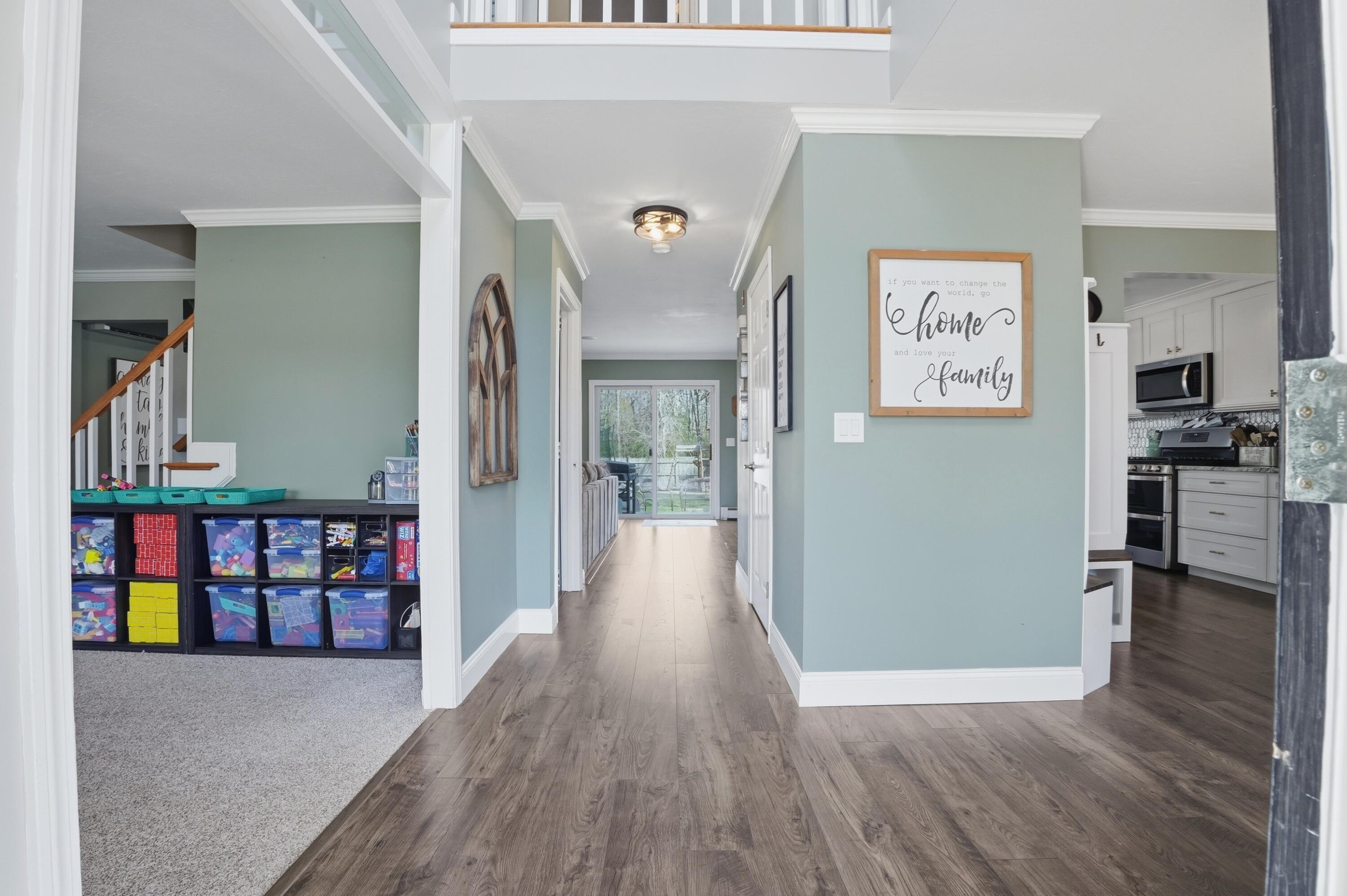 3 Dover Lane Buzzards Bay, MA 02532 - Photo 5 of 51 a view of a hallway with wooden floor and dining room