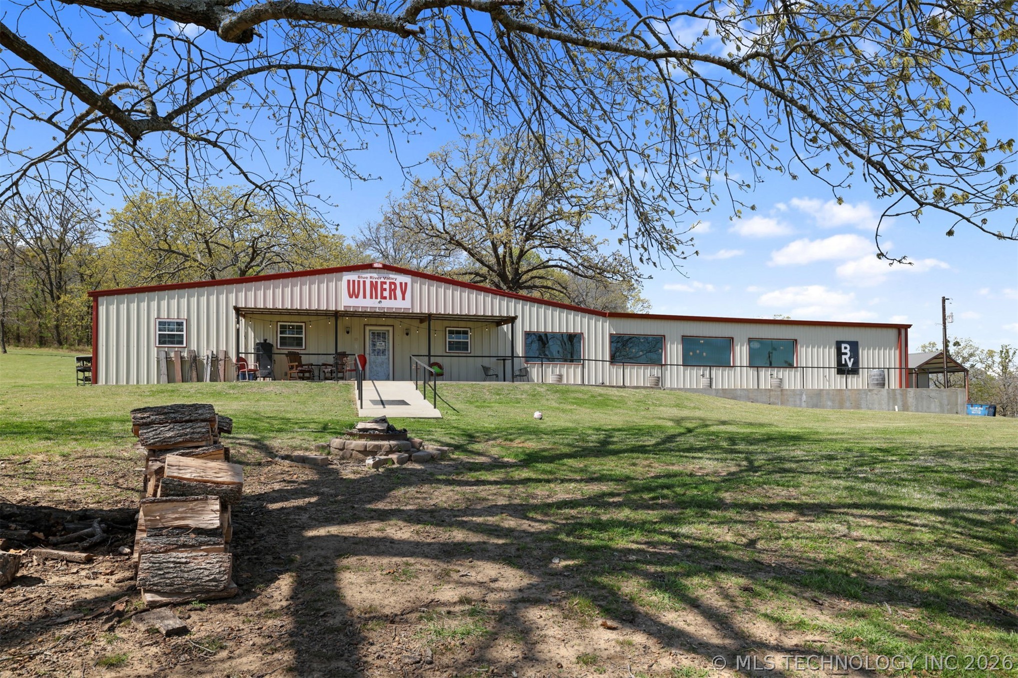 3565 Sawmill Road Caddo, OK 74729 - Photo 1 of 32 Commercial building featuring a corrugated metal exterior, covered front porch, and a concrete ramp leading to the entrance