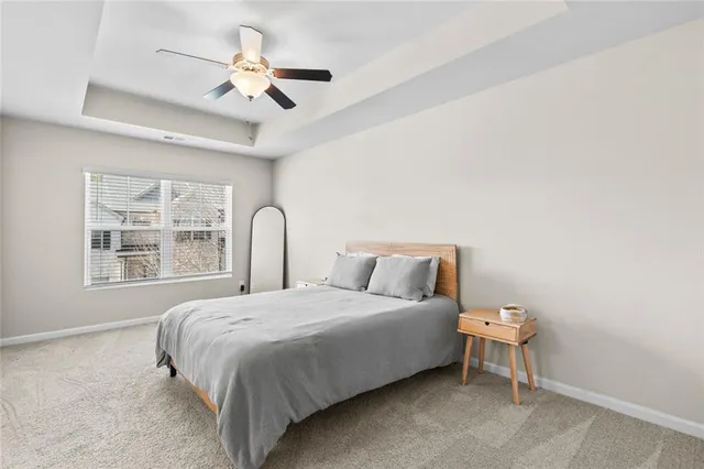 a bedroom with a bed and a large window