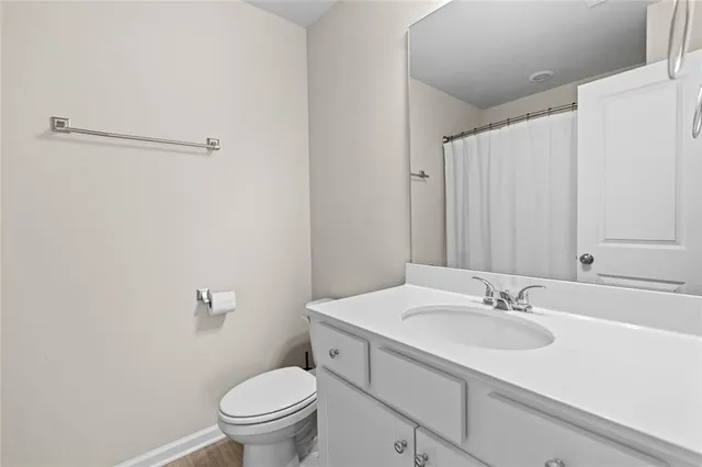 a bathroom with a sink toilet and a mirror