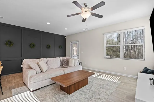 a living room with furniture and a large window