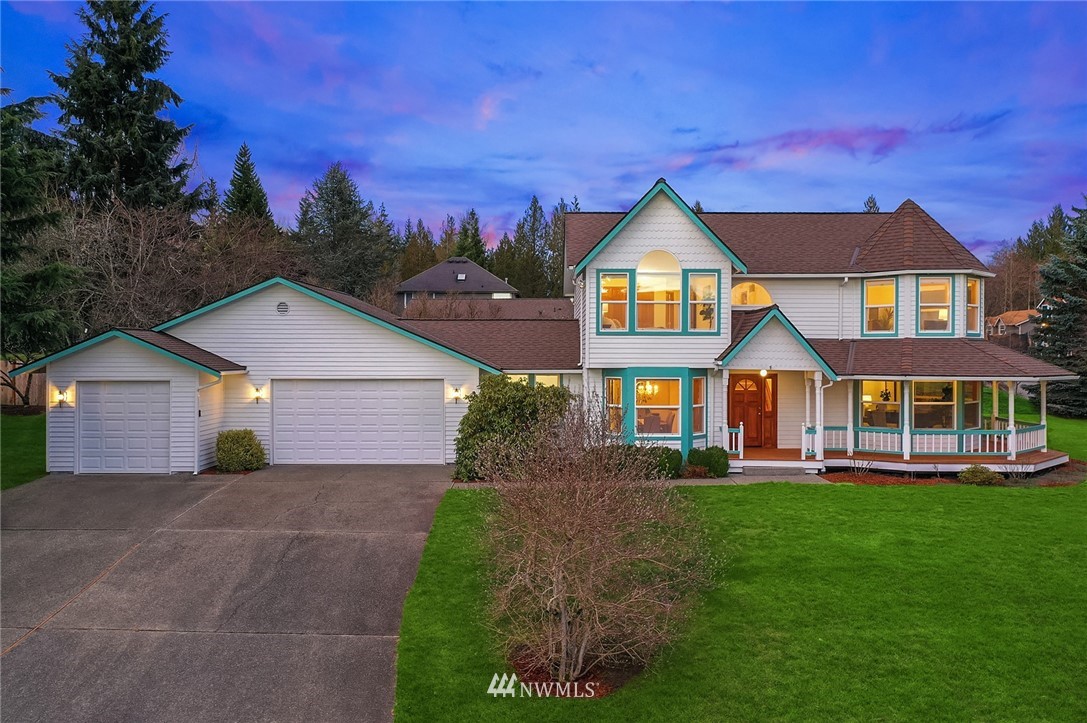 14010 282nd Lane Northeast Duvall, WA 98019 - Photo 1 of 31 a front view of a house with a yard and garage