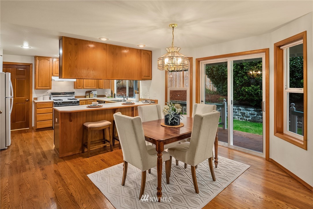 14010 282nd Lane Northeast Duvall, WA 98019 - Photo 11 of 31 a view of a dining room with furniture window and wooden floor