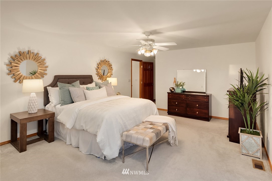 14010 282nd Lane Northeast Duvall, WA 98019 - Photo 16 of 31 a spacious bedroom with a bed and a chandelier