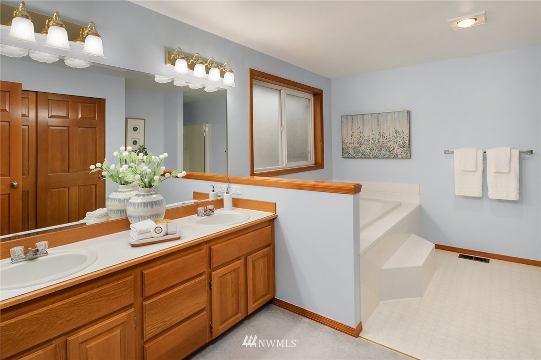 14010 282nd Lane Northeast Duvall, WA 98019 - Photo 17 of 31 a bathroom with a sink double vanity granite and a mirror