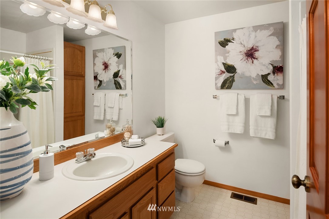 14010 282nd Lane Northeast Duvall, WA 98019 - Photo 19 of 31 a bathroom with a sink and mirror with toilet