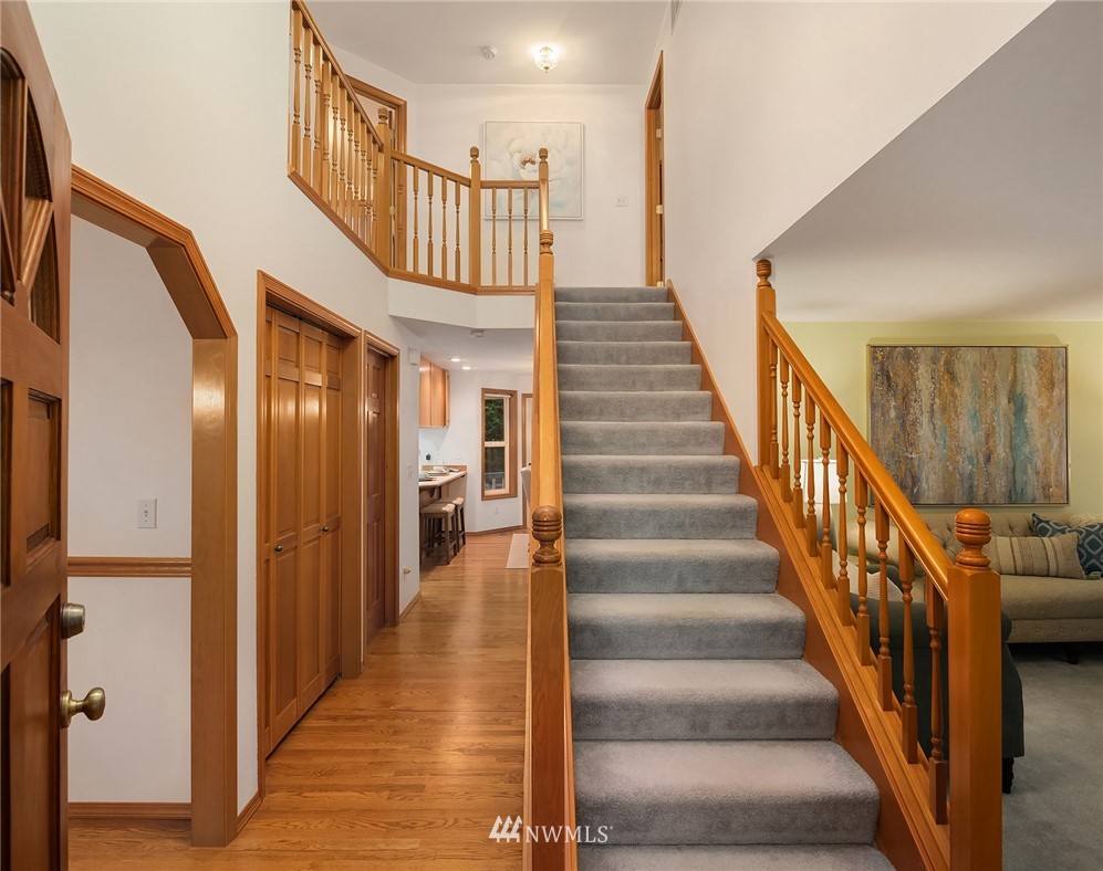 14010 282nd Lane Northeast Duvall, WA 98019 - Photo 2 of 31 a view of staircase with lots of frames on wall and wooden floor