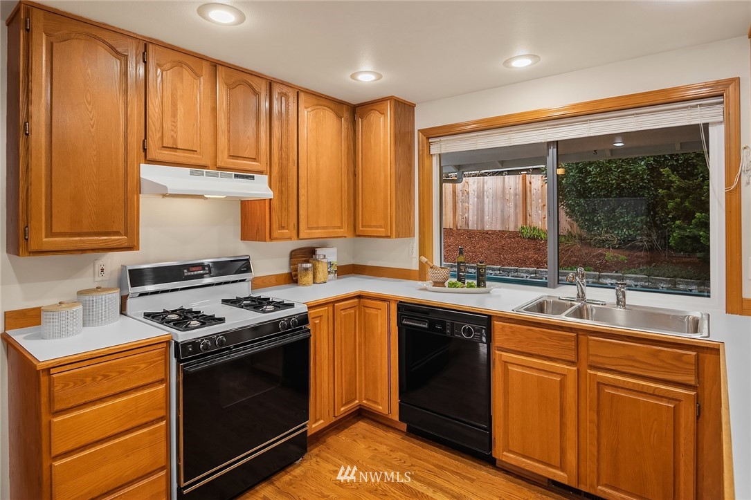 14010 282nd Lane Northeast Duvall, WA 98019 - Photo 10 of 31 a kitchen with a sink stove top oven and cabinets
