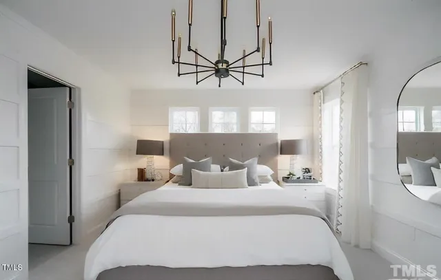 a kitchen with stainless steel appliances granite countertop a stove top oven a refrigerator a dining table and chairs with wooden floor