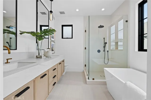 a bathroom with a double vanity sink and a bathtub