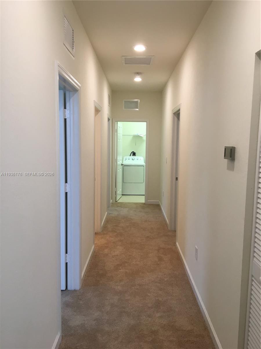 191 Southeast 35 Avenue Homestead, FL 33033 - Photo 19 of 22 a view of a hallway with wooden floor and a bathroom