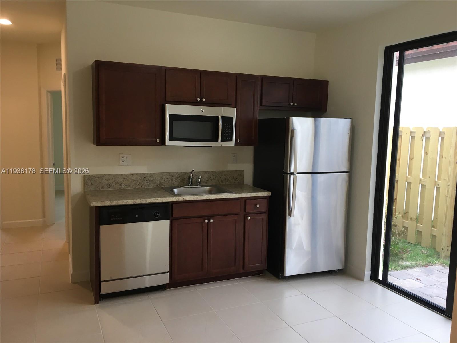 191 Southeast 35 Avenue Homestead, FL 33033 - Photo 22 of 22 a kitchen with granite countertop stainless steel appliances and refrigerator