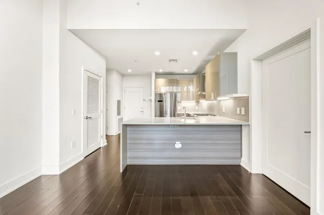 a view of kitchen cabinets and wooden floor