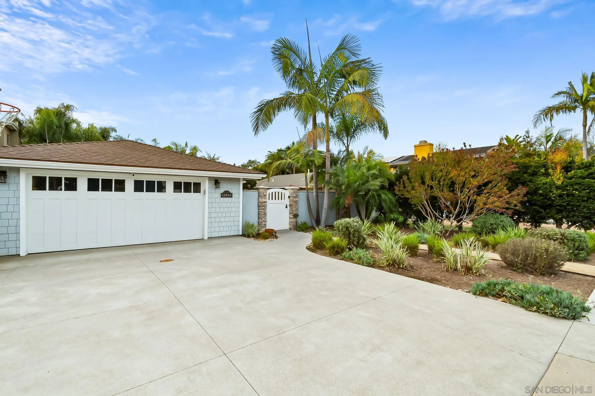 13814 Recuerdo Drive Del Mar, CA 92014 - Photo 4 of 31 a view of a white house with a yard and potted plants