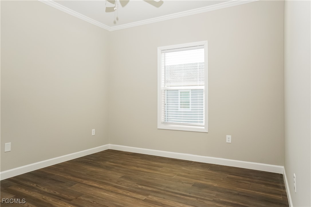 12315 Tangier Street North Port, FL 34287 - Photo 11 of 16 an empty room with wooden floor and windows